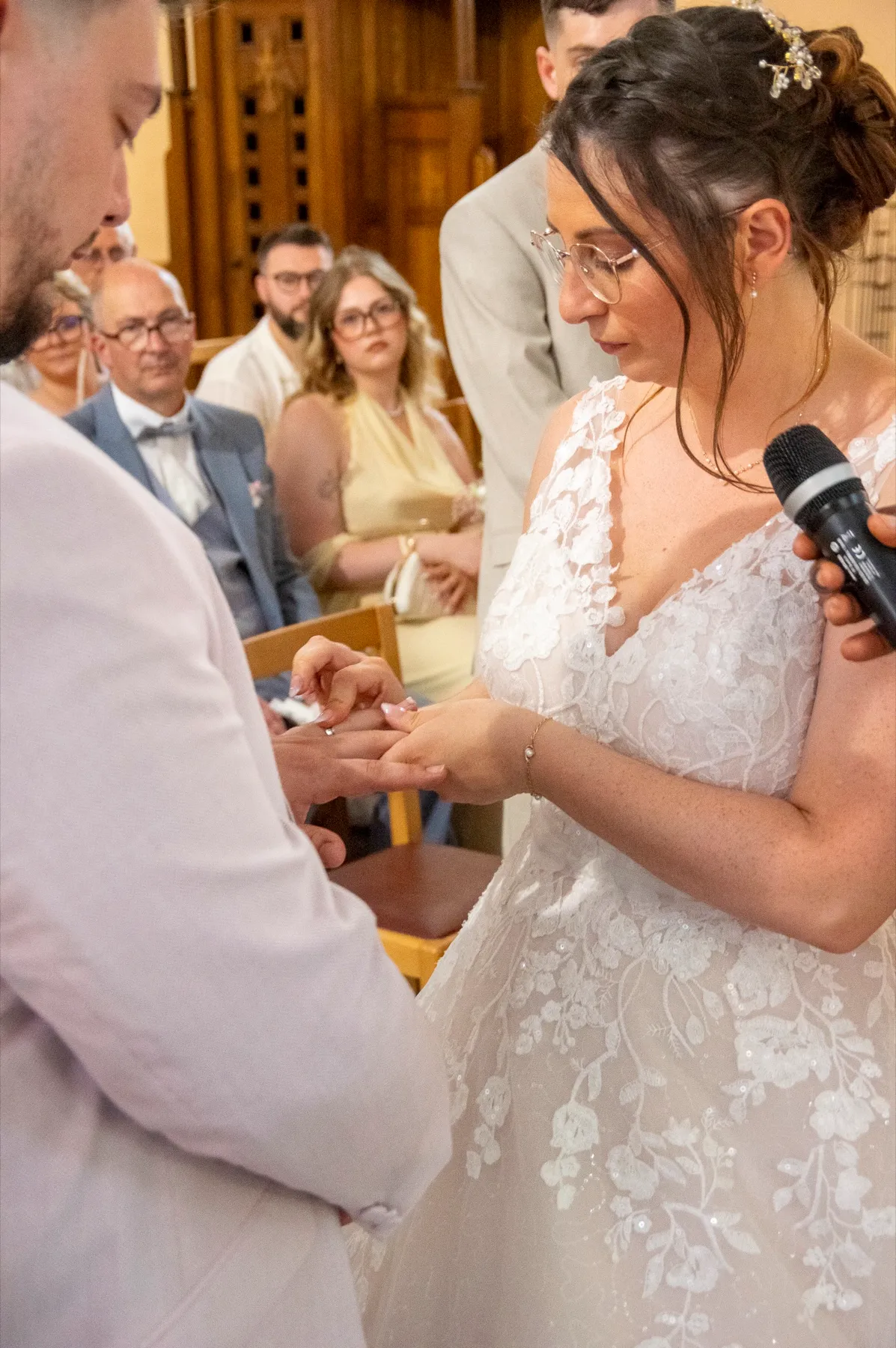La mariée, micro en main, passe l’alliance au doigt du marié